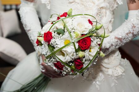 Beautiful bridal bouquet in hands of the bride. Stylish bride with a bouquet of pink roses.の写真素材