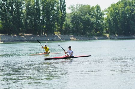 Bendery,Pridnestrove, June 18-19,2015 competition of rowing. Open Championship Pridnestrove rowing. Sportsmen in sport kayaks paddles on the water.のeditorial素材