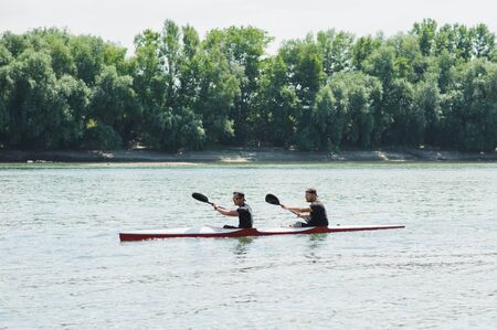 Bendery,Pridnestrove, June 18-19,2015 competition of rowing. Open Championship Pridnestrove rowing. Sportsmen in sport kayaks paddles on the water.のeditorial素材