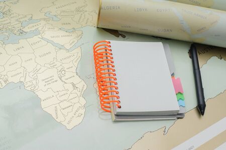 Modern notebook, map, pen on texture background.Space for text. Travel and holiday concept.の写真素材