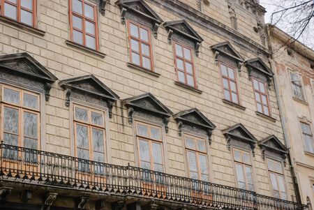 Facade of an ancient building with windowsの写真素材