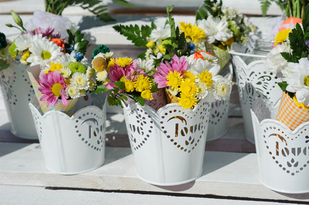Buckets of beautiful purple and white flowers prepared for wedding ceremony or another festive event. Decorateの写真素材