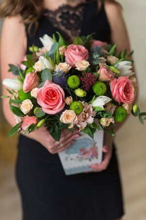 Flowers in the hands of a woman. Close-upの写真素材