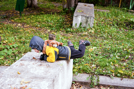 a boy walks on an autumn dayの写真素材