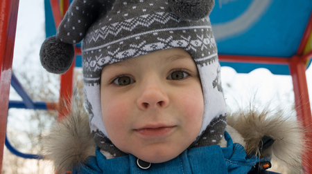 a child with big eyes looks into the cameraの写真素材