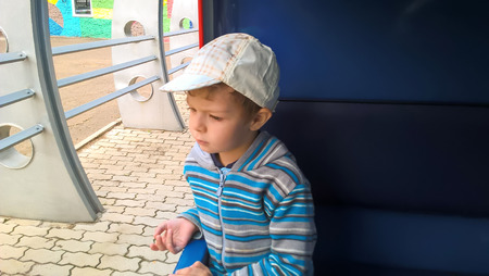 the boy in the car of the children's railwayの写真素材