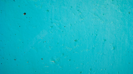 the concrete wall of the building is painted with green colorの写真素材