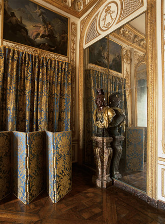 Versailles, France - 10 August 2014 : Wooden room with gold ornament and large mirror at Versailles Palace ( Chateau de Versailles ). It was added to the UNESCO list of World Heritage Sites.のeditorial素材