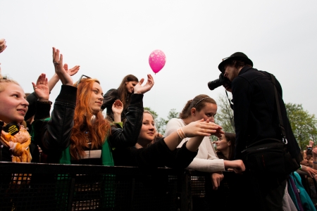 Prague, Czech Republic - 30.4.12013 - Photographer takes a photo over fence at Majalesのeditorial素材