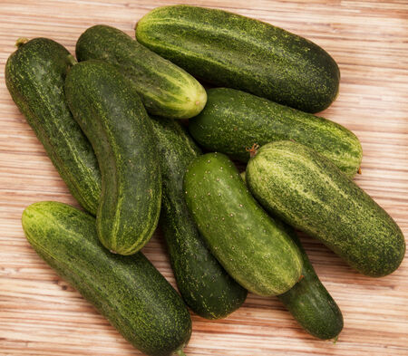 fresh cucumbers on a wooden backgroundの写真素材
