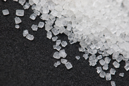 white sugar on a black backgroundの写真素材