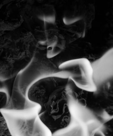 black-and-white flame fire on a black backgroundの写真素材