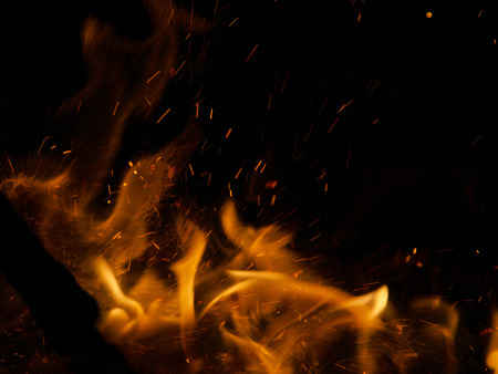 Fire flames on a black background with sparks