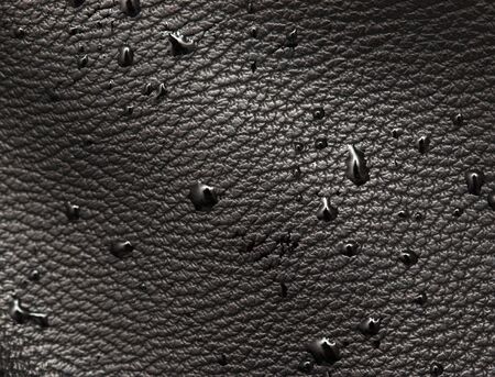 drops of water on black leatherの写真素材