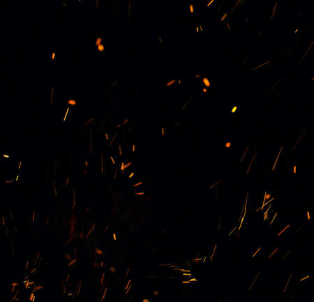 flames of fire with sparks black backgroundの写真素材