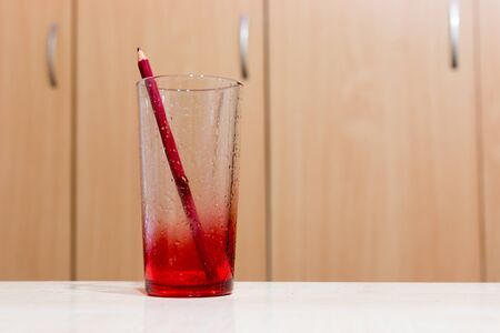 red transparent glass on the tableの写真素材