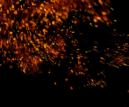 Flame of fire with sparks on a black backgroundの写真素材