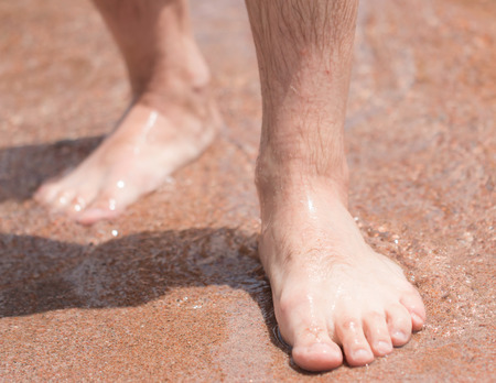 feet in the sand on the beachの写真素材