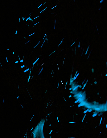 blue sparks of fire on a black background