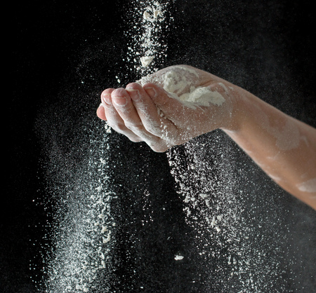 Flour hands on a black backgroundの写真素材
