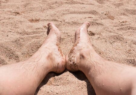 feet in the sand on the beachの写真素材