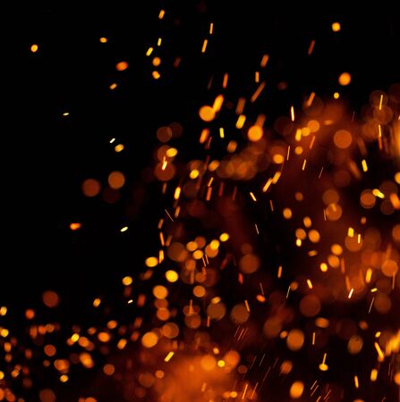 Flame of fire with sparks on a black backgroundの写真素材