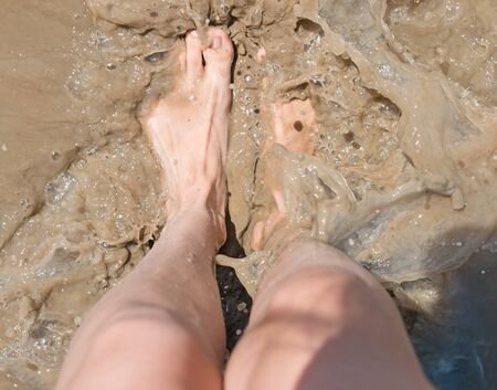 Foot in dirty waterの写真素材