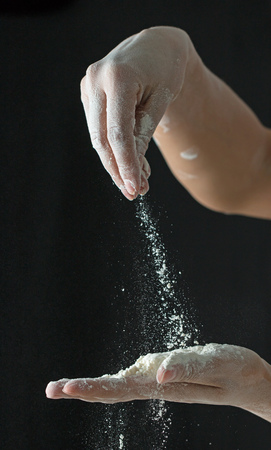 Flour hands on a black backgroundの写真素材