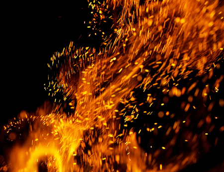 Flame of fire with sparks on a black background