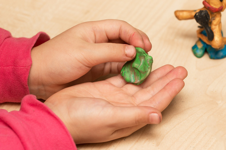 children's hands playing with plasticineの写真素材