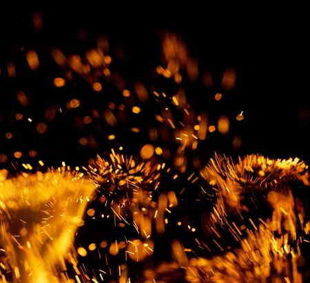 flame of fire with sparks on a black backgroundの写真素材