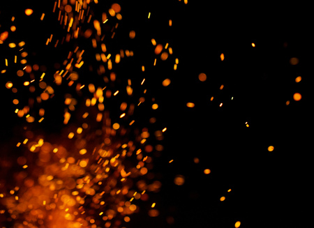 Flame of fire with sparks on a black backgroundの写真素材