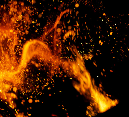 Flame of fire with sparks on a black background