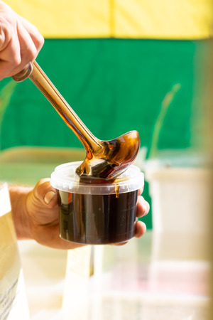 a stream of fresh liquid honeyの写真素材