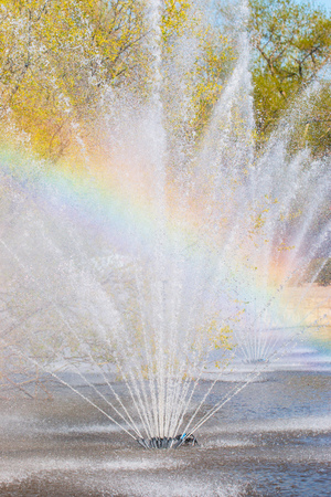 city fountain with a rainbowの写真素材