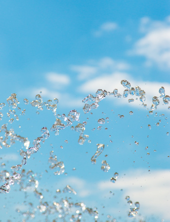 water jet with spray on the sky backgroundの写真素材