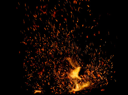 flame of fire with sparks on a black backgroundの写真素材