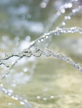 water jet with splashes as backgroundの写真素材