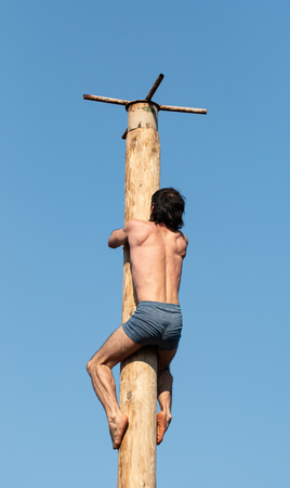 outdoor sports man on a wooden postの写真素材