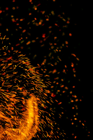 flame of fire with sparks on a black backgroundの写真素材