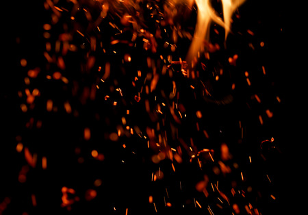 flame of fire with sparks on a black backgroundの写真素材