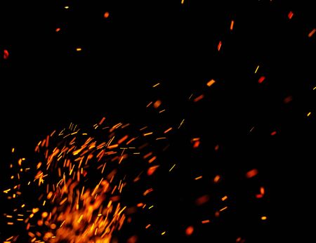 flame of fire with sparks on a black backgroundの写真素材