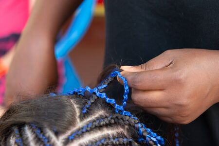 weaving thin braids on the head