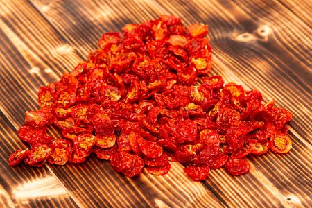 dried cherry tomatoes on wooden backgroundの写真素材