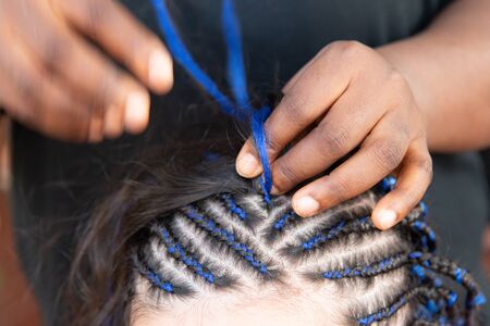 weaving thin braids on the head
