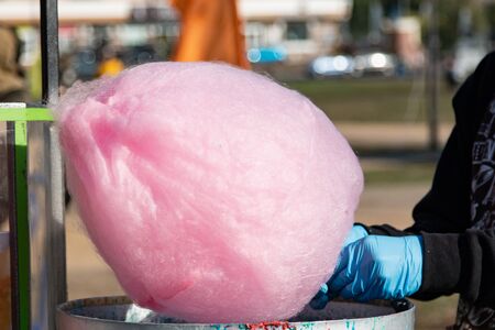 hands make candy floss in the park