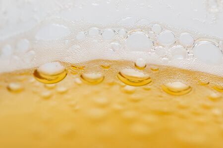 bubbles with beer foam as backgroundの写真素材