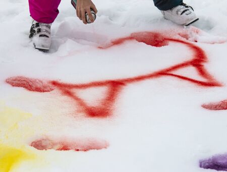 children's hand paints in the snowの写真素材
