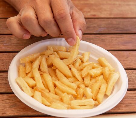fried potatoes on wooden background