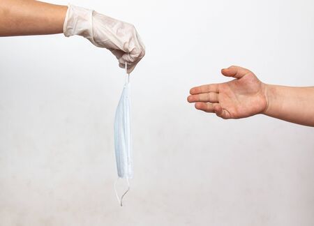 child hand takes medical mask for protection